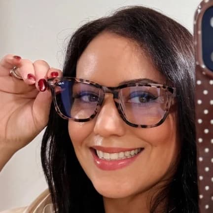 Isabella L. wearing her refreshed frames with progressive Transitions lenses