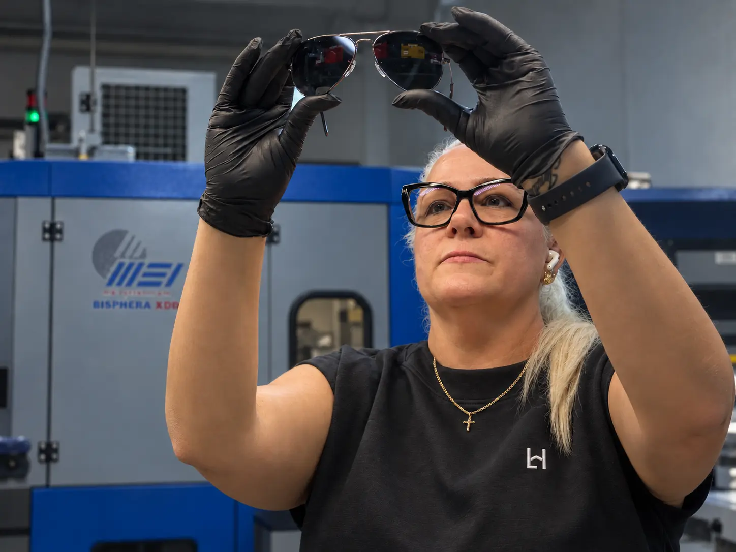 A Lenshaus lab technician inspecting a finished pair of sunglasses